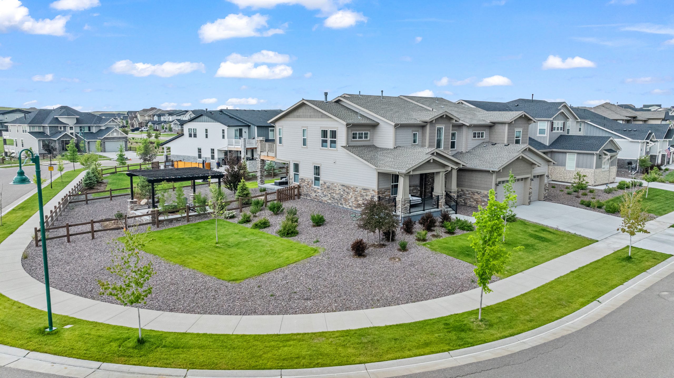 Drone view from southwest showing corner lot layout