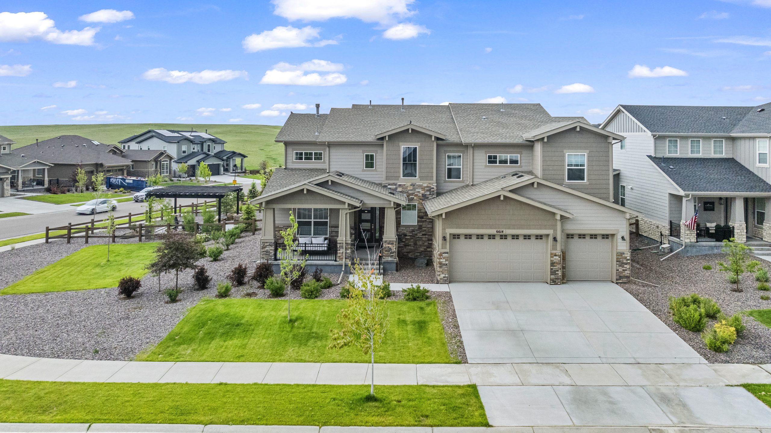 Center-front aerial shot showcasing driveway and landscaping
