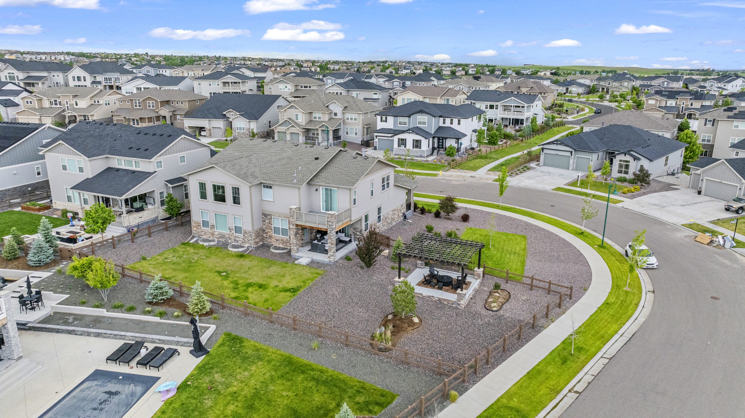 High-angle view capturing property and adjacent streetscape