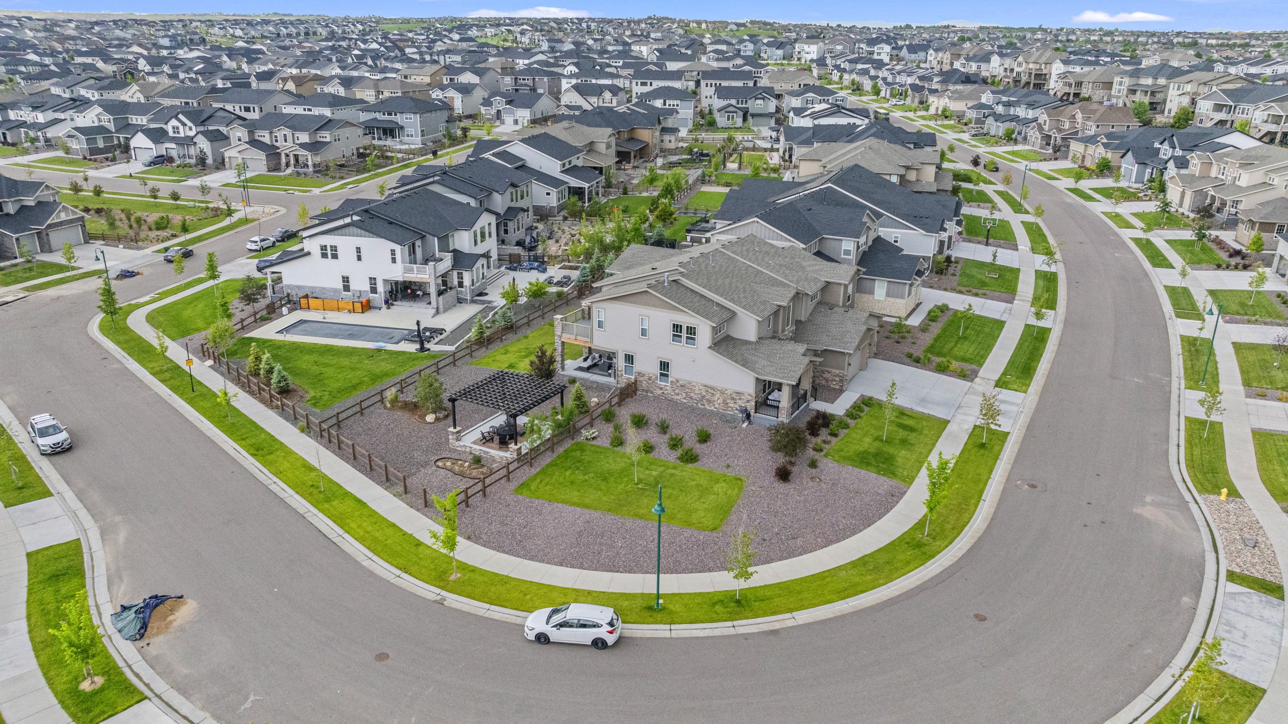 Tilted aerial view emphasizing lot shape and curving road