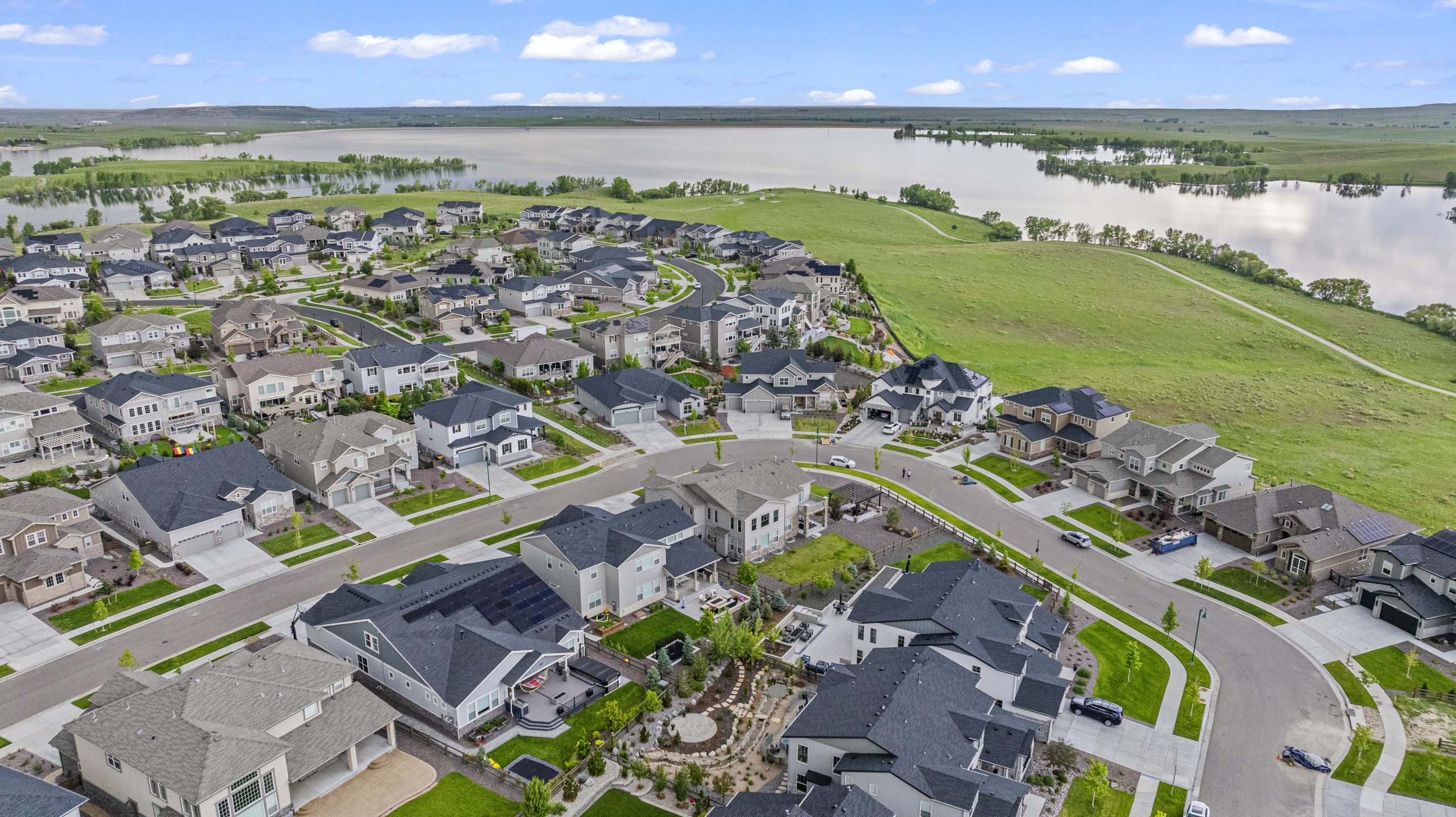 Wide drone shot capturing entire neighborhood curve and waterfront view